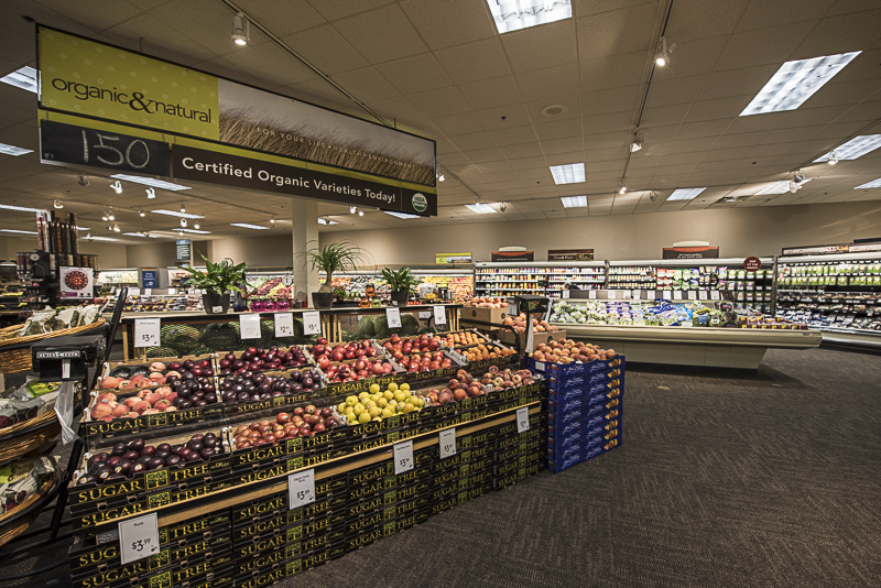 A produce section with a carpeted floor.