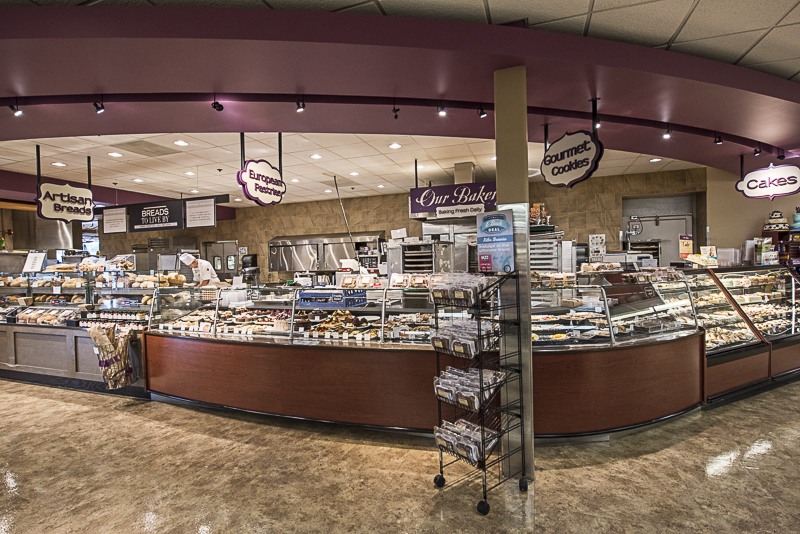 The bakery section. There are signs for bread, gourmet cookies and cakes.