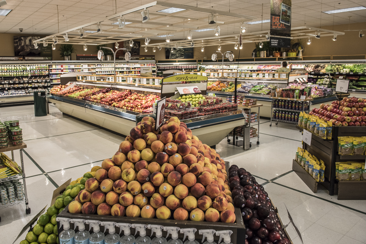 A produce section with stacked nectarines.